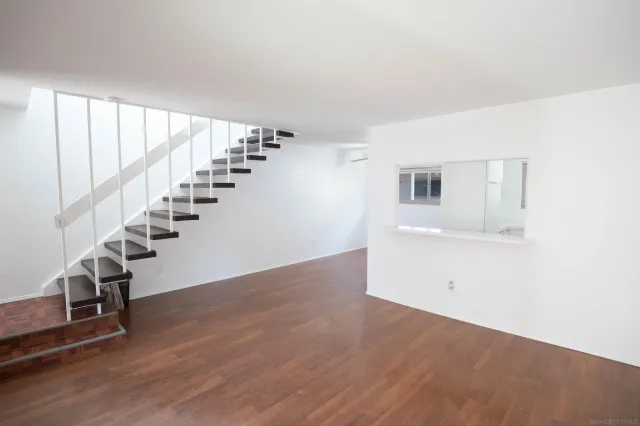 a view of an empty room with stairs