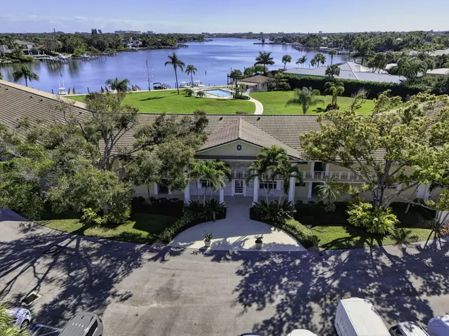 an aerial view of a house with a garden and lake view