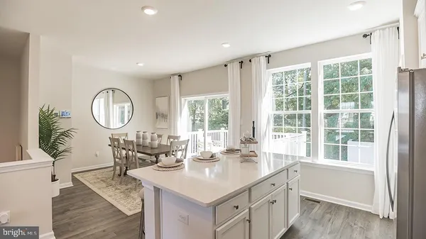 a kitchen with granite countertop a sink a stove and a wooden floors