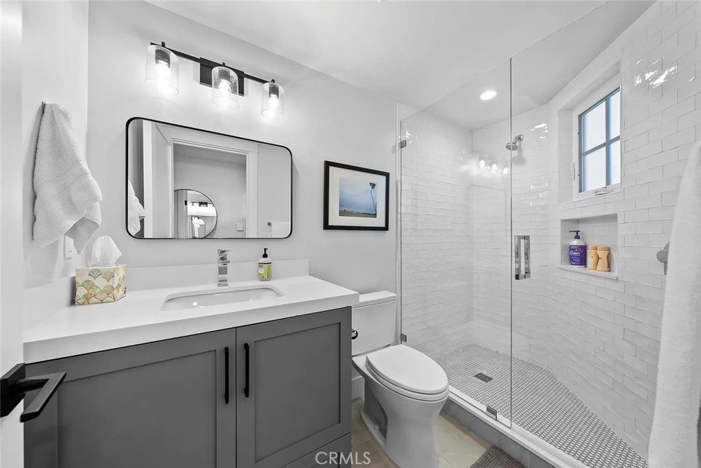 309 Crest Drive Manhattan Beach, CA 90266 - Photo 21 of 27 a bathroom with a toilet a sink a mirror a vanity and shower