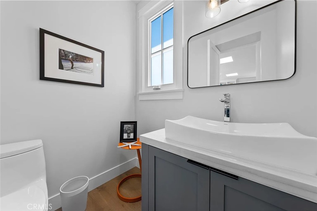 309 Crest Drive Manhattan Beach, CA 90266 - Photo 22 of 27 a bathroom with a toilet a sink and mirror