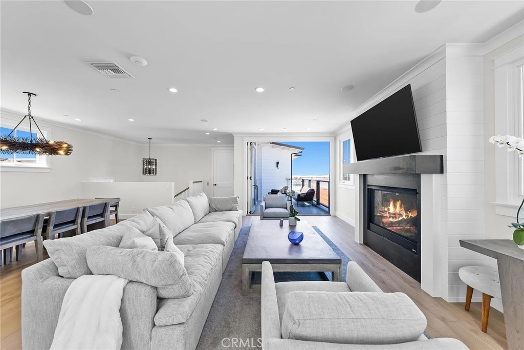 309 Crest Drive Manhattan Beach, CA 90266 - Photo 3 of 27 a living room with furniture a flat screen tv and a fireplace