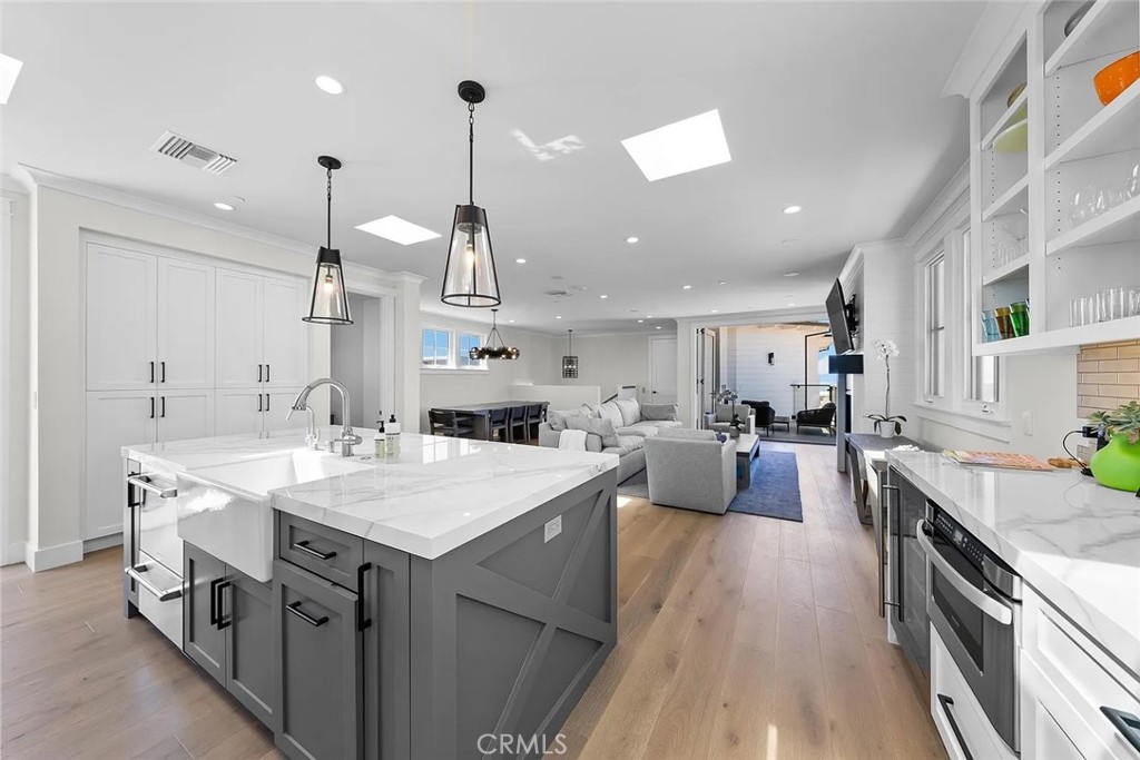 309 Crest Drive Manhattan Beach, CA 90266 - Photo 5 of 27 a large kitchen with stainless steel appliances a stove a sink a oven a dining table and chairs