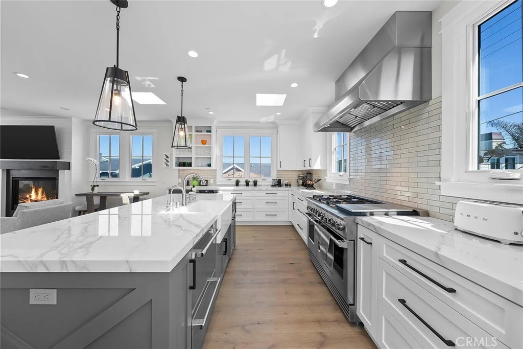 309 Crest Drive Manhattan Beach, CA 90266 - Photo 6 of 27 a kitchen with granite countertop kitchen island stainless steel appliances a stove sink and cabinets