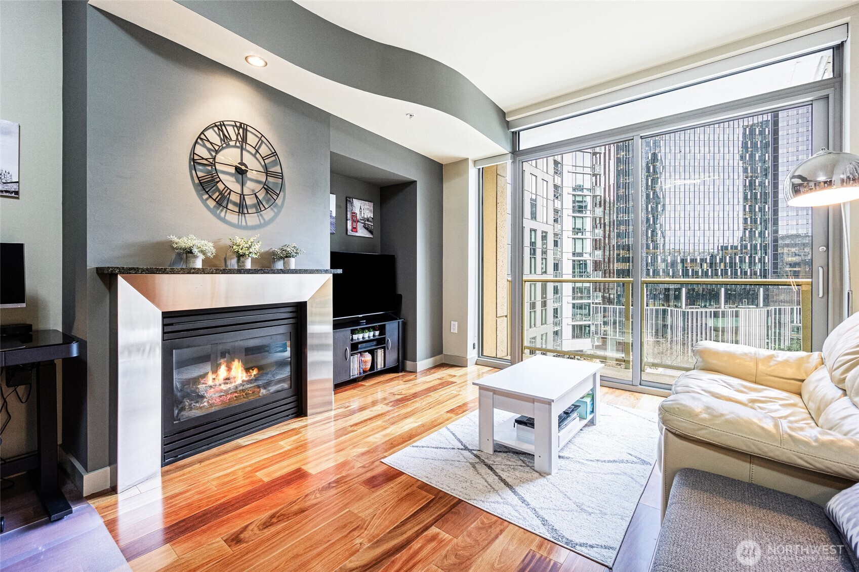 900 Lenora Street, Unit 804 Seattle, WA 98121 - Photo 12 of 38 a living room with a fireplace furniture a flat screen tv and a fireplace