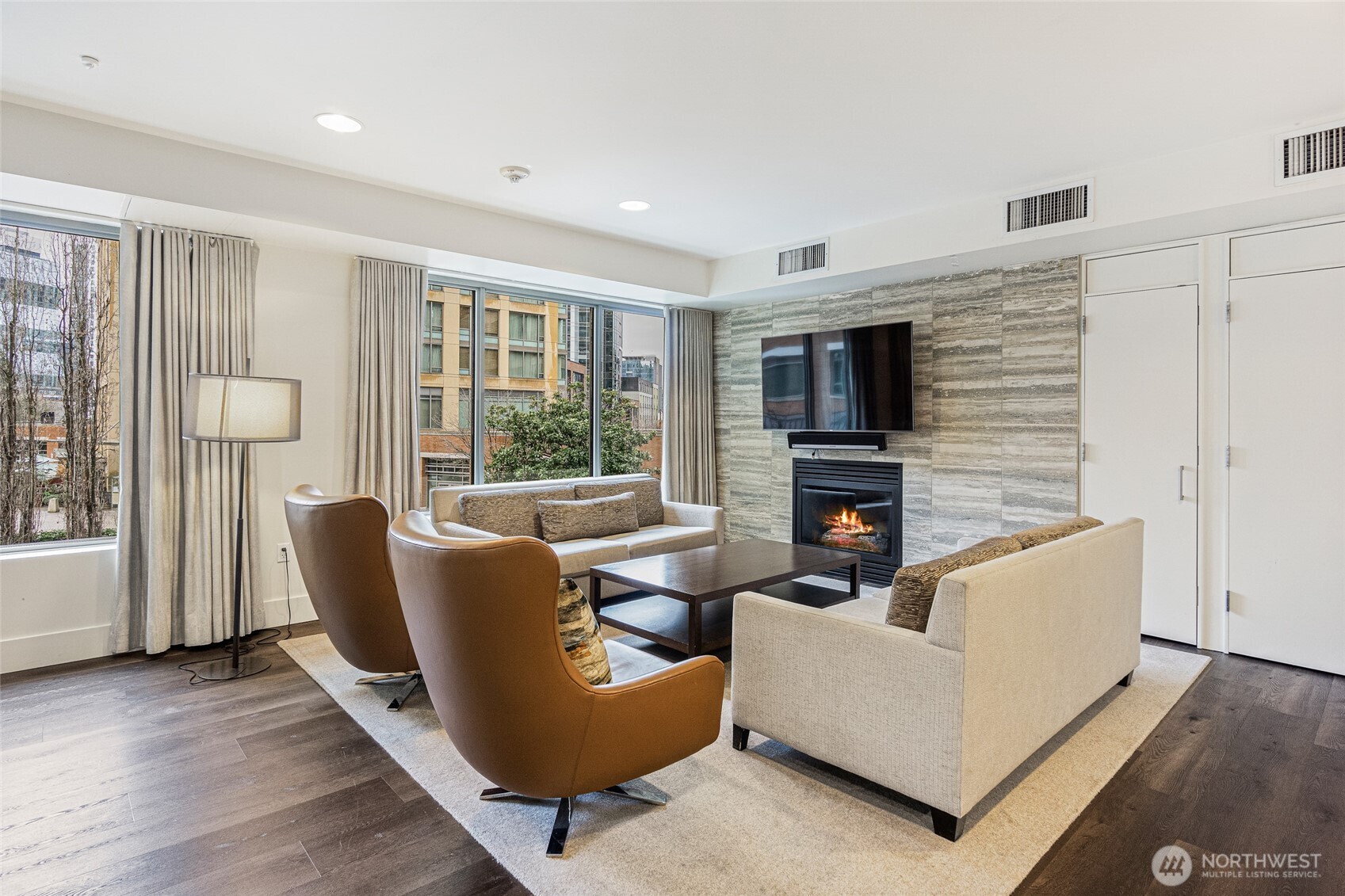 900 Lenora Street, Unit 804 Seattle, WA 98121 - Photo 29 of 38 a living room with furniture and a fireplace