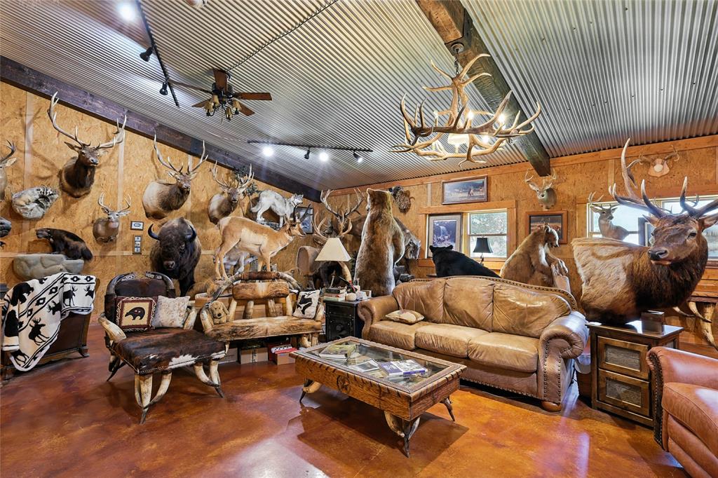 12370 Fortenberry Road Sanger, TX 76266 - Photo 11 of 40 Living area featuring finished concrete floors, a chandelier, and ceiling fan