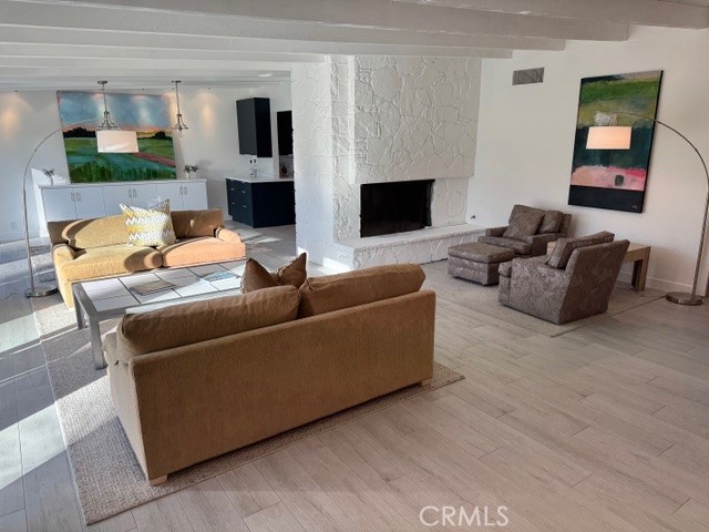 36927 Palm View Road Rancho Mirage, CA 92270 - Photo 13 of 18 a living room with furniture wooden floor and a fireplace