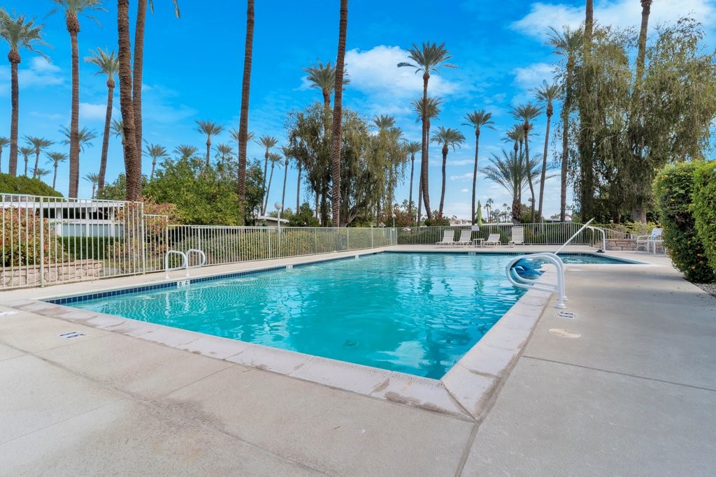 36927 Palm View Road Rancho Mirage, CA 92270 - Photo 9 of 18 a view of a swimming pool with a lawn chairs and palm tree