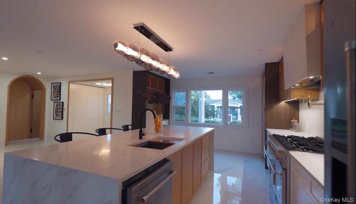21 Wesleyan Road Commack, NY 11725 - Photo 5 of 9 a kitchen with stainless steel appliances granite countertop a sink a stove and a refrigerator