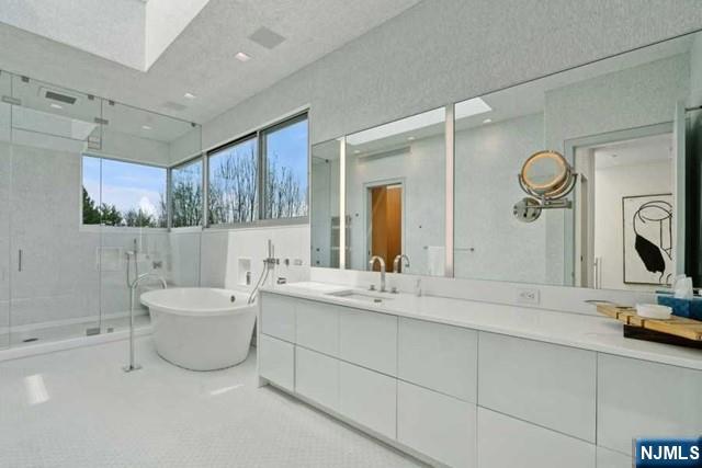 532 Winthrop Road Teaneck, NJ 07666 - Photo 14 of 42 a bathroom with a double vanity sink mirror and bathtub