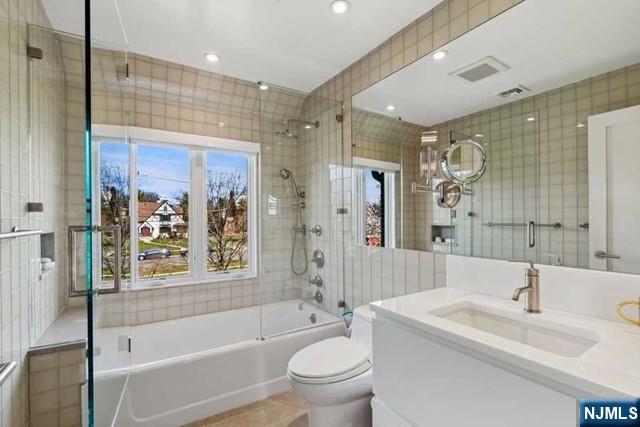 532 Winthrop Road Teaneck, NJ 07666 - Photo 19 of 42 a bathroom with a bathtub shower sink mirror vanity and toilet