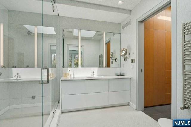 532 Winthrop Road Teaneck, NJ 07666 - Photo 26 of 42 a bathroom with a shower sink and mirror