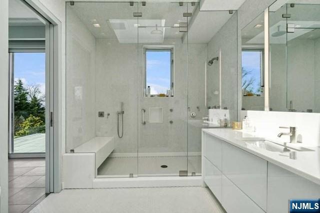 532 Winthrop Road Teaneck, NJ 07666 - Photo 27 of 42 a bathroom with a shower a mirror and a sink
