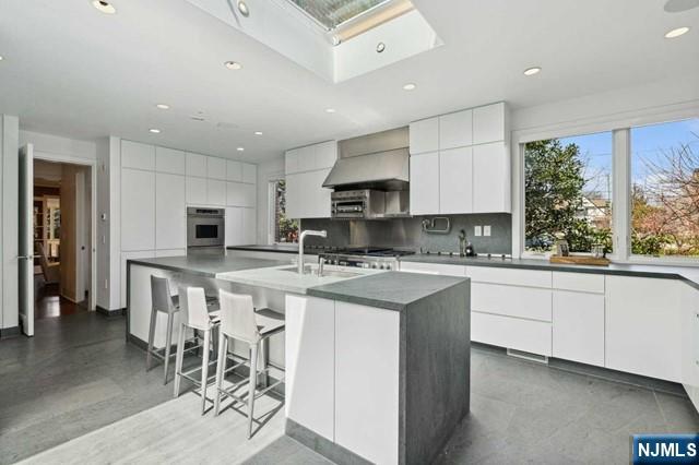 532 Winthrop Road Teaneck, NJ 07666 - Photo 6 of 42 a kitchen with appliances a sink a counter top space and a center island
