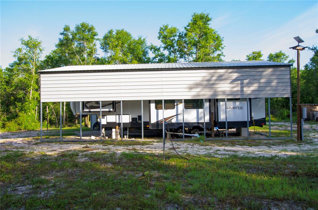18233 185th Road Live Oak, FL 32060 - Photo 29 of 99 a view of a house with a yard porch and sitting area