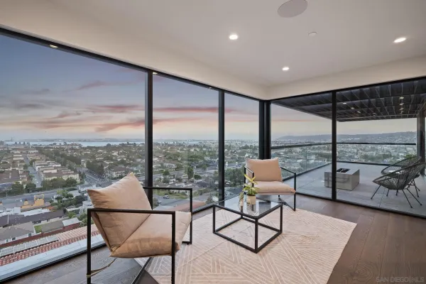 a living room with furniture and a floor to ceiling window
