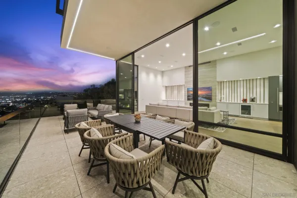 a dining room with furniture and a floor to ceiling window