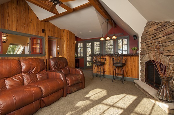 94 Devonshire Road Newton, MA 02468 - Photo 11 of 17 a living room with furniture a fireplace and a flat screen tv