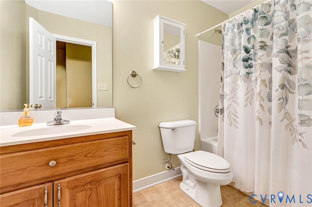 19423 Indian Road Petersburg, VA 23805 - Photo 18 of 34 a bathroom with a granite countertop toilet sink and mirror