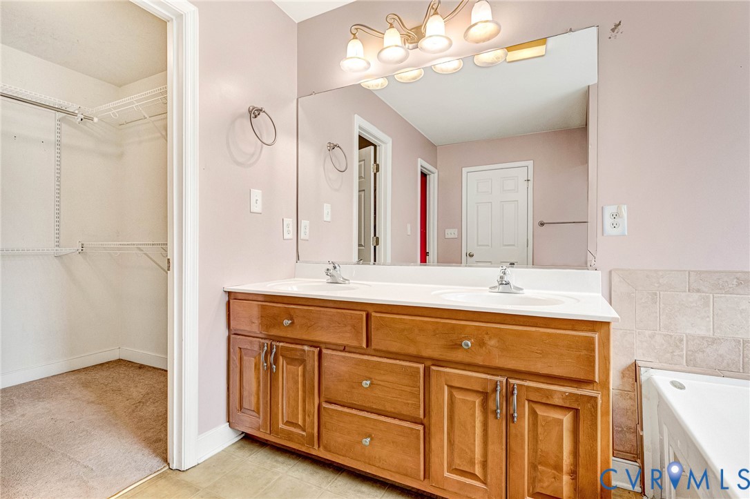 19423 Indian Road Petersburg, VA 23805 - Photo 25 of 34 a spacious bathroom with a double vanity sink a mirror and a shower