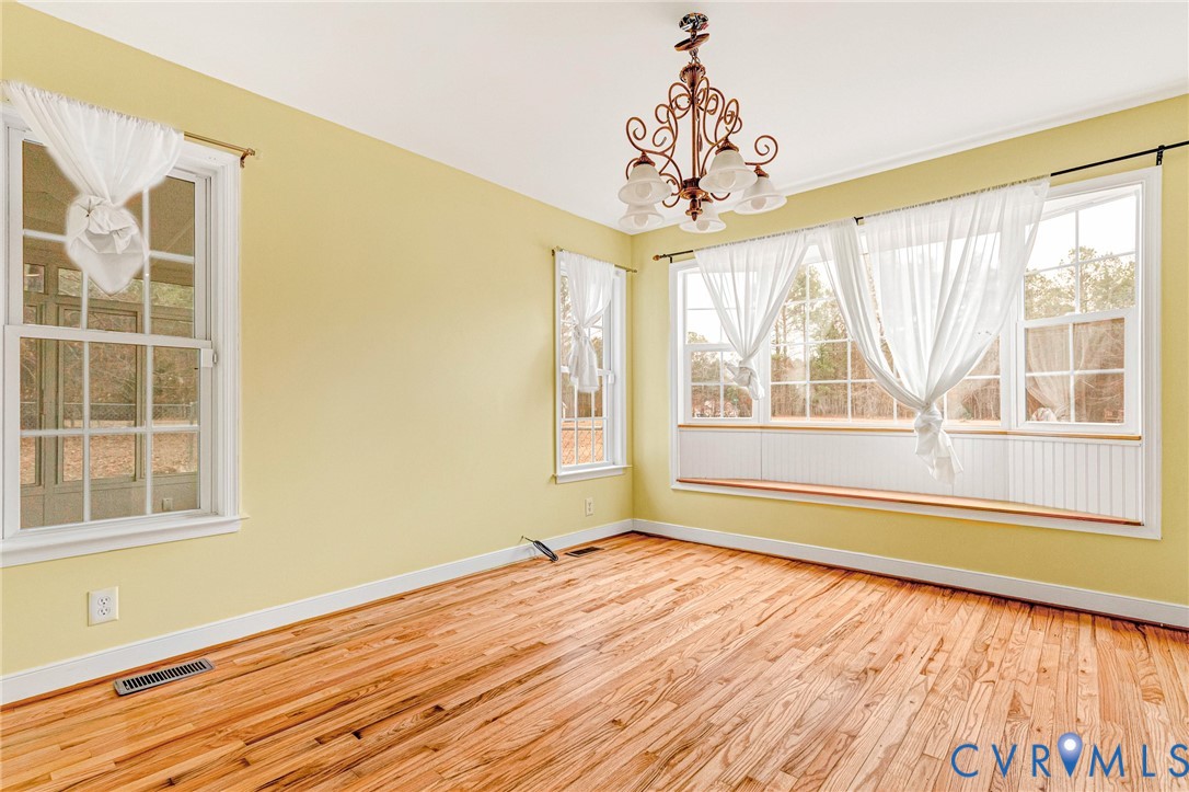 19423 Indian Road Petersburg, VA 23805 - Photo 5 of 34 a view of an empty room with a window and wooden floor