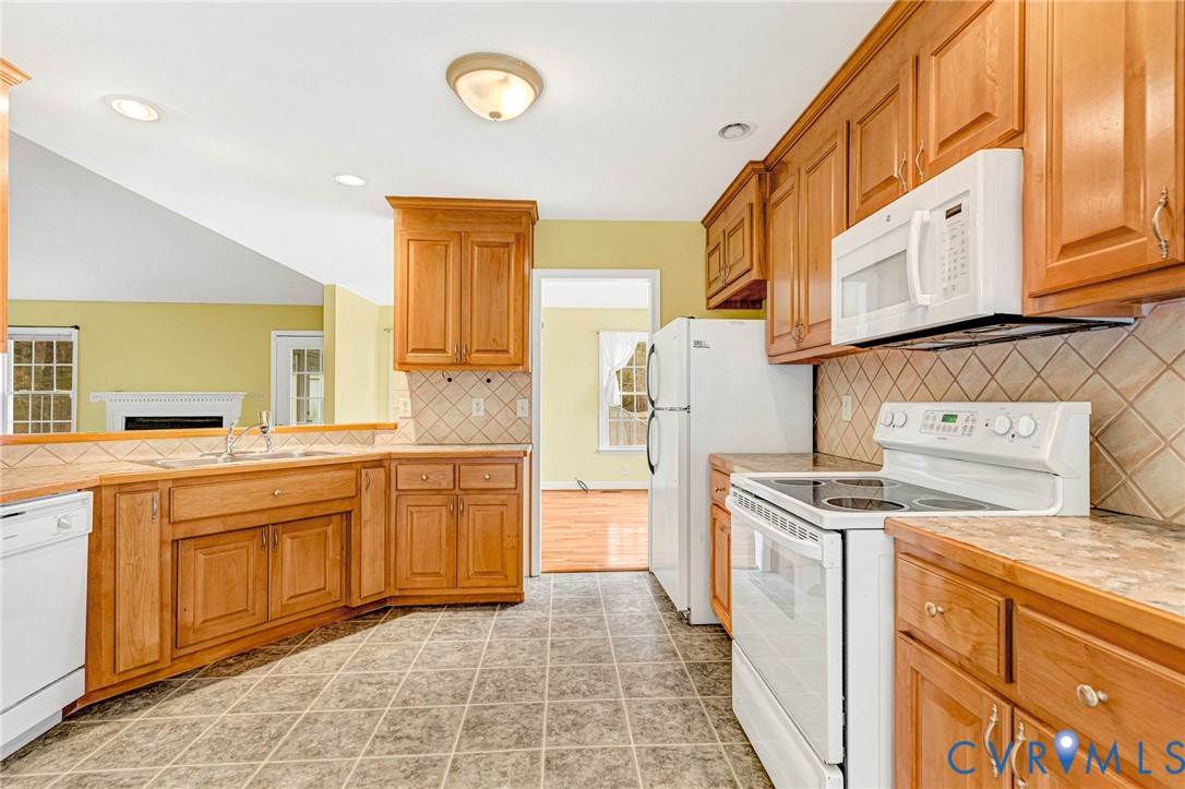 19423 Indian Road Petersburg, VA 23805 - Photo 7 of 34 a kitchen with a stove a sink and a refrigerator