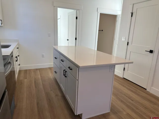 a kitchen with stainless steel appliances a refrigerator stove and microwave