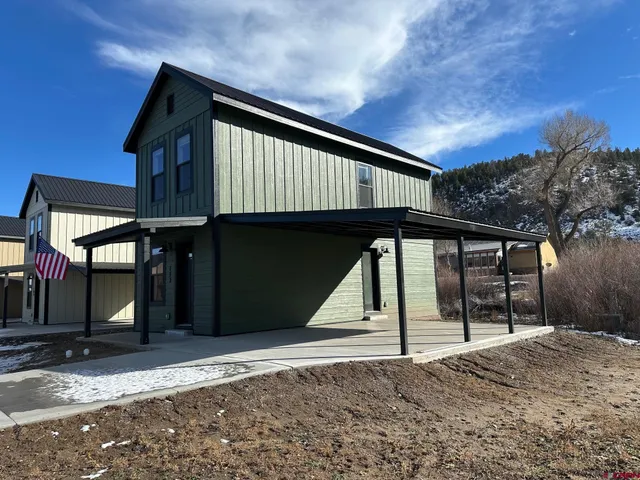 a view of wooden house with large windows