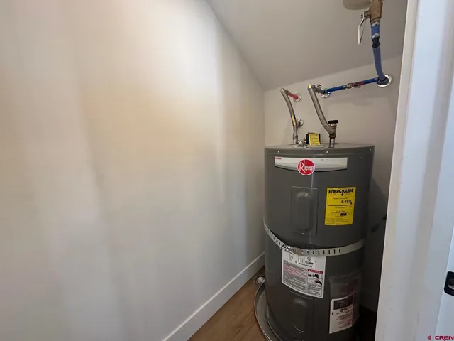 a view of a hallway with closet and wooden floor