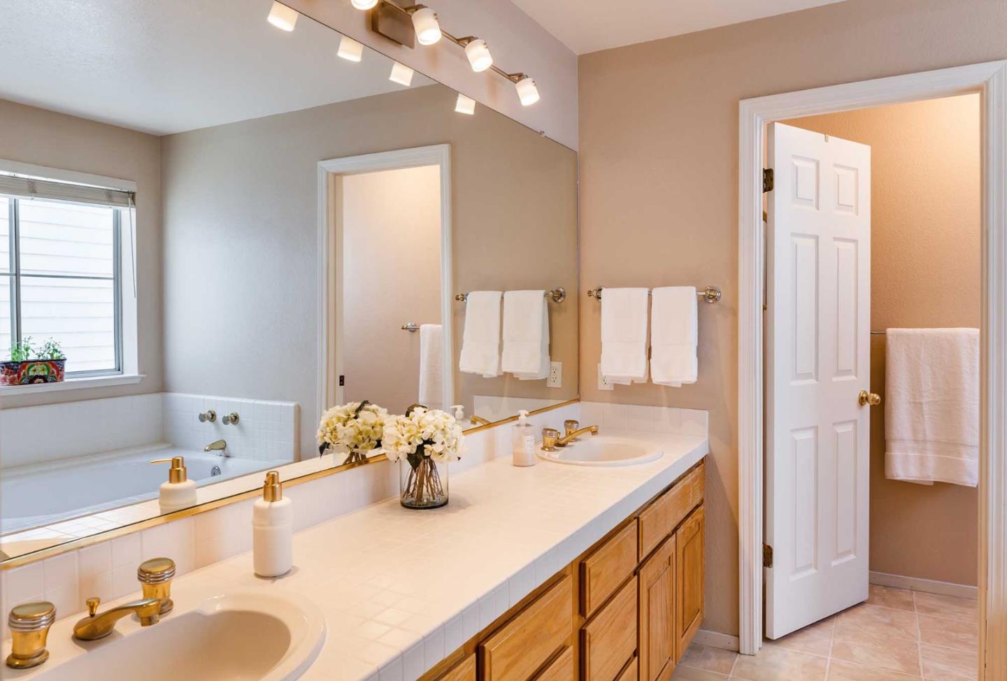 2052 Jamison Place Santa Clara, CA 95051 - Photo 20 of 24 a bathroom with a tub sink and mirror