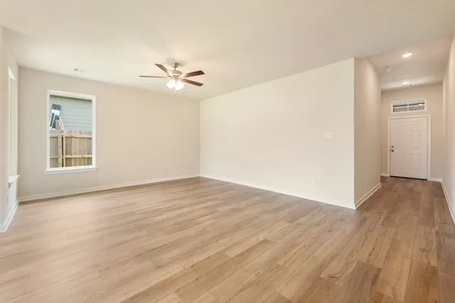 wooden floor in an empty room with a window