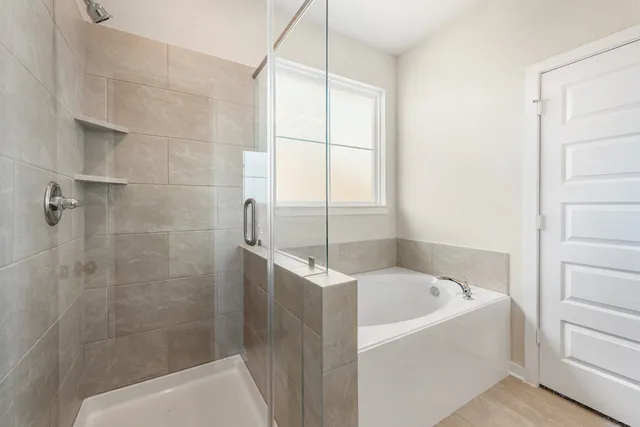 a bathroom with a bathtub and shower
