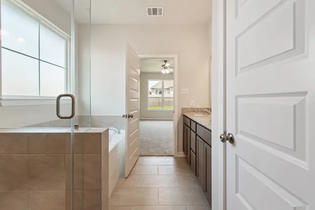 a bathroom with a sink a toilet and a shower