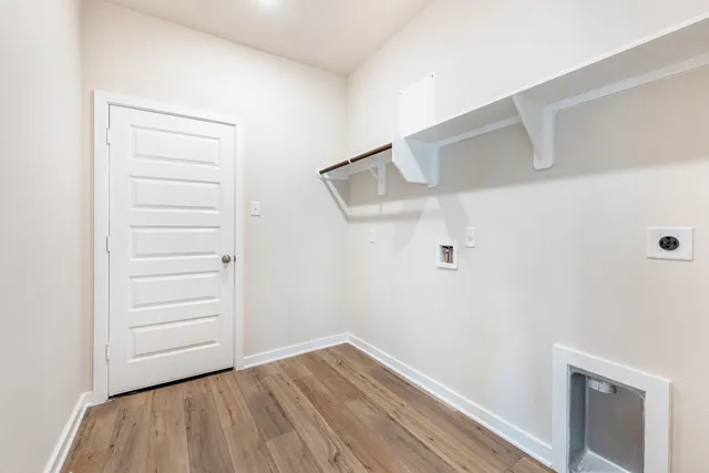 a view of a room with wooden floor