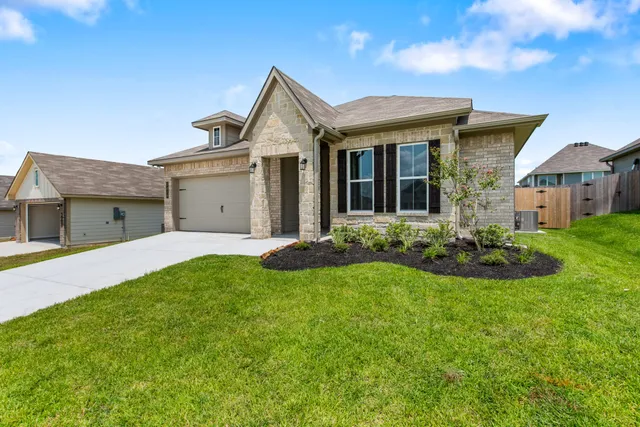 a view of a house with garden and yard