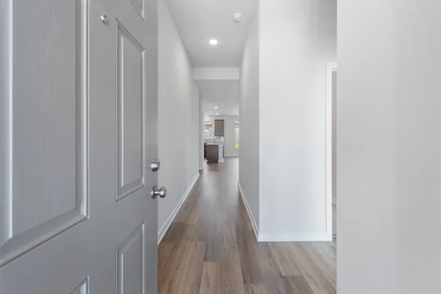 a view of a hallway with wooden floor