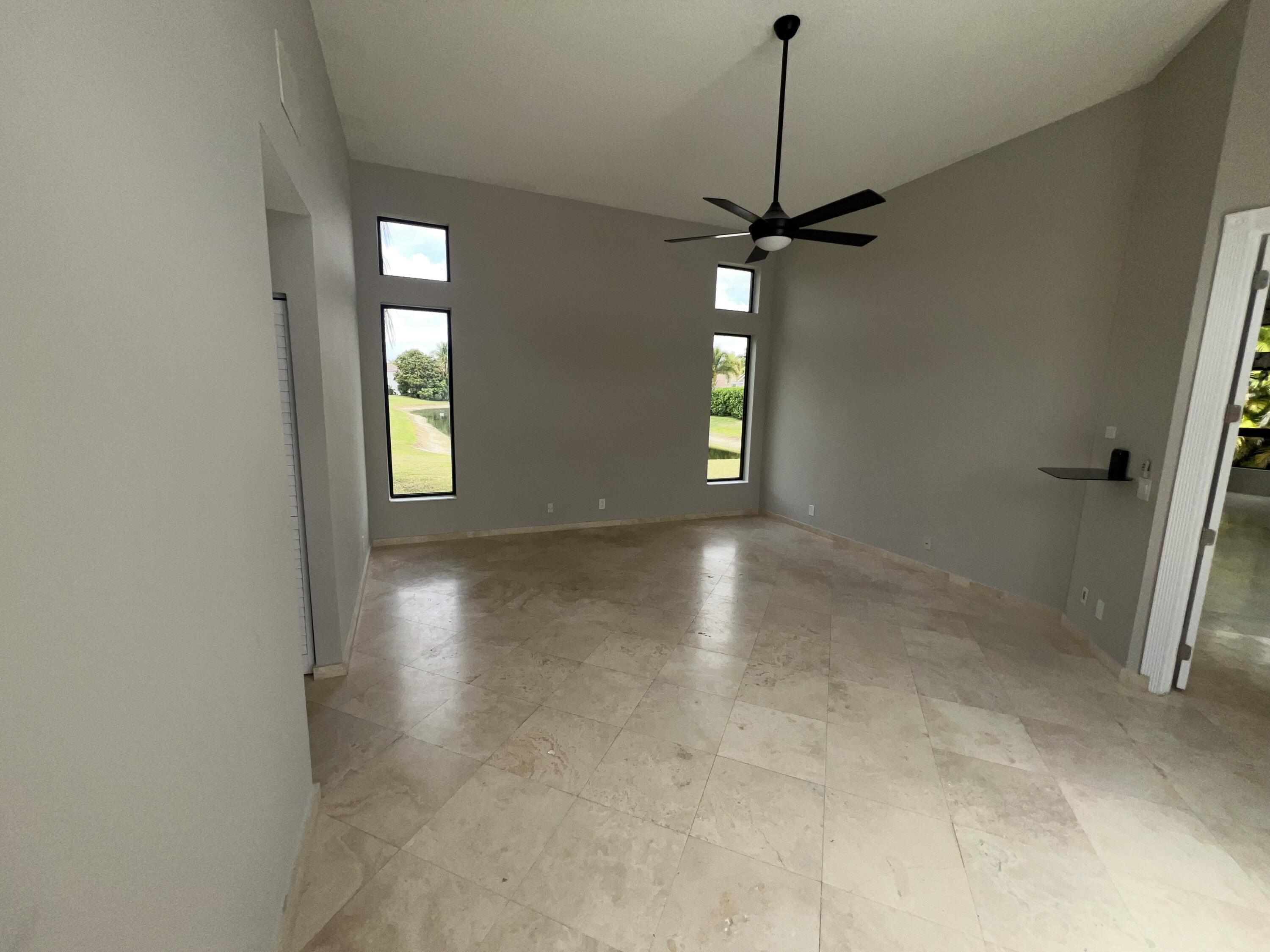 20077 Palm Island Drive Boca Raton, FL 33498 - Photo 16 of 47 a view of a room with window hardwood floor and a ceiling fan