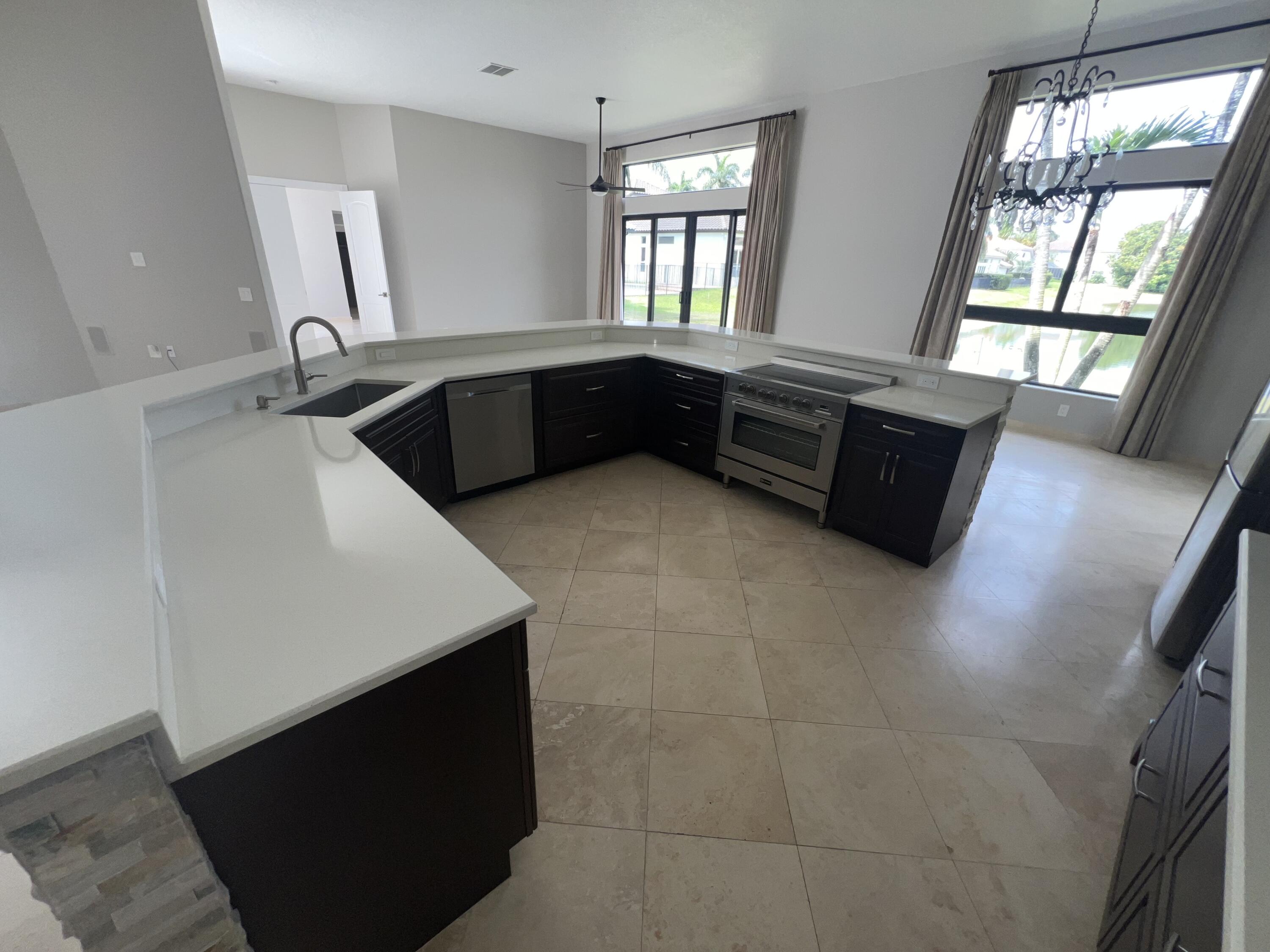 20077 Palm Island Drive Boca Raton, FL 33498 - Photo 22 of 47 a kitchen with stainless steel appliances a sink a stove and a window