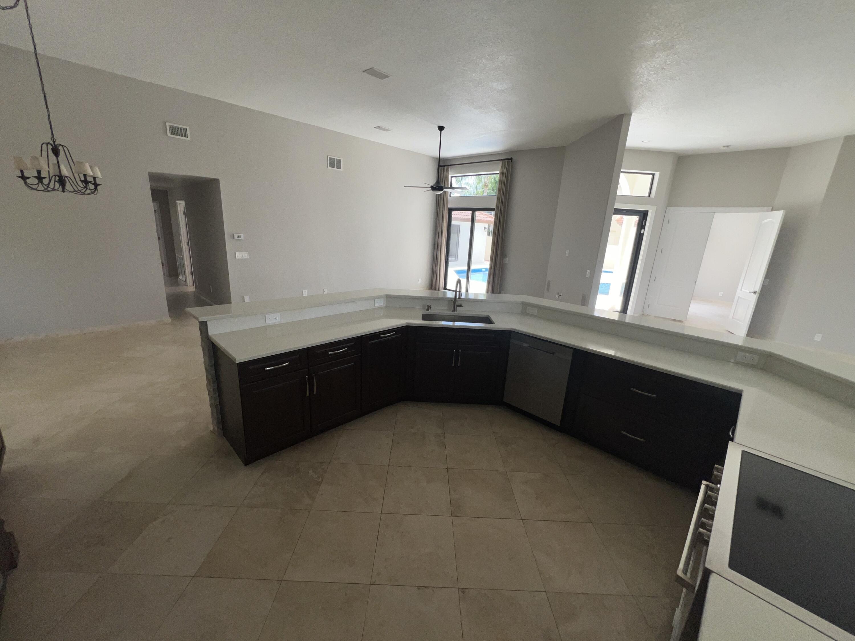 20077 Palm Island Drive Boca Raton, FL 33498 - Photo 23 of 47 a kitchen with granite countertop a sink and a stove