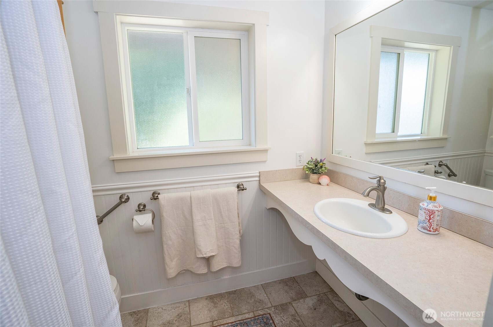 16412 50th St Court Southwest Longbranch, WA 98351 - Photo 11 of 35 a bathroom with a sink and mirror