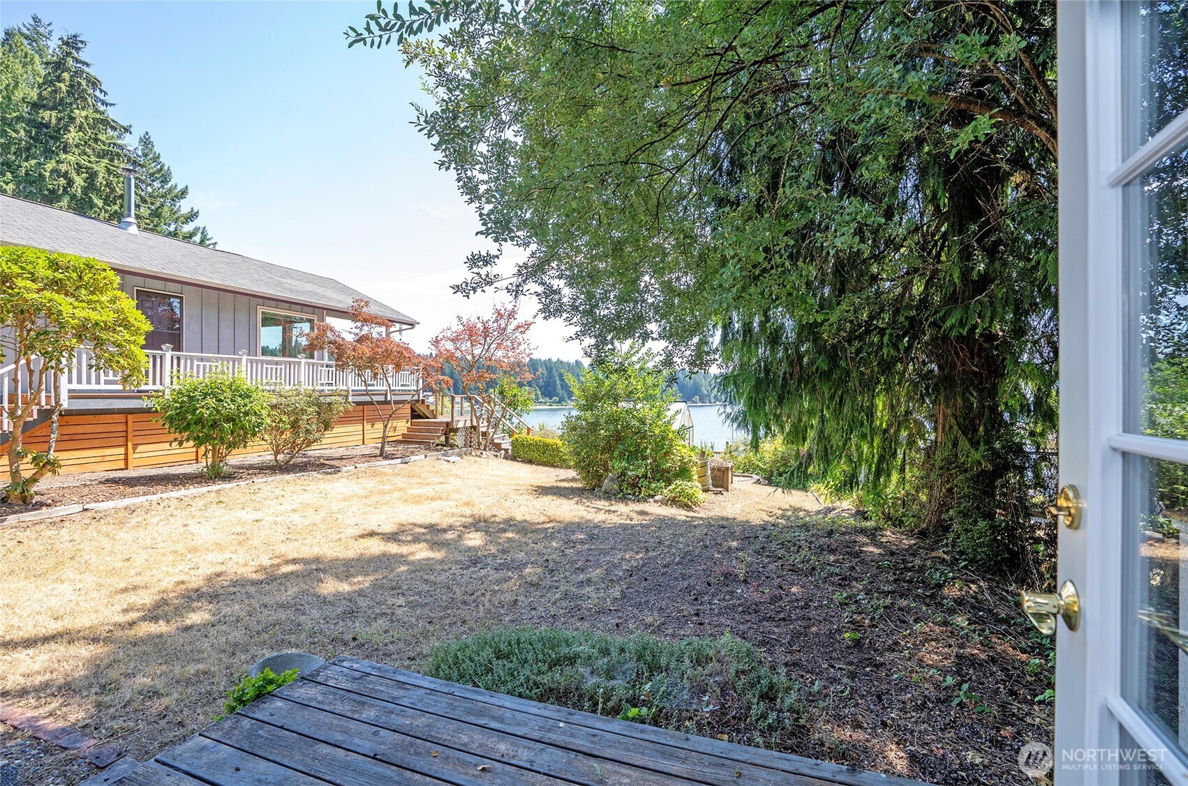 16412 50th St Court Southwest Longbranch, WA 98351 - Photo 19 of 35 a view of a yard with plants and trees