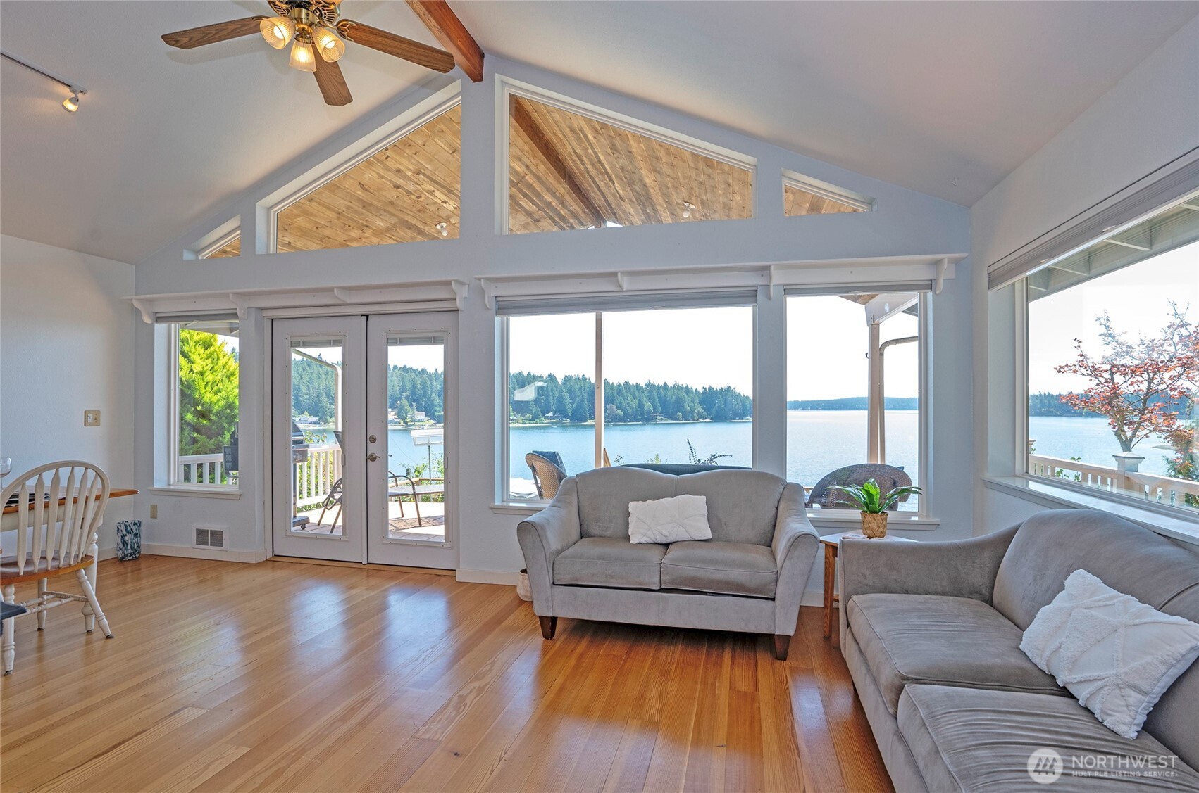 16412 50th St Court Southwest Longbranch, WA 98351 - Photo 6 of 35 a living room with furniture and floor to ceiling windows