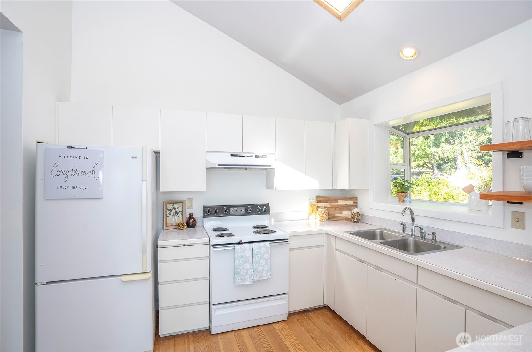 16412 50th St Court Southwest Longbranch, WA 98351 - Photo 9 of 35 a kitchen with white cabinets and white appliances