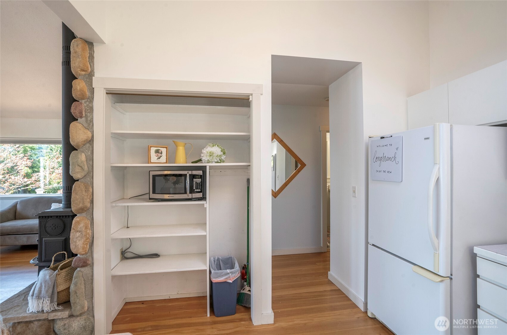 16412 50th St Court Southwest Longbranch, WA 98351 - Photo 10 of 35 a view of a hallway with wooden floor and dining room view
