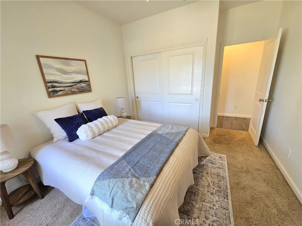 225 Sparrow Court Red Bluff, CA 96080 - Photo 13 of 29 a bedroom with a bed and a painting on the wall