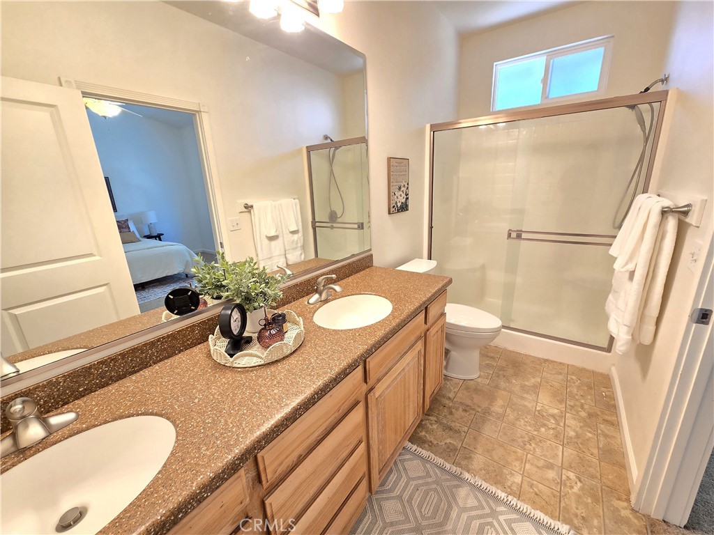 225 Sparrow Court Red Bluff, CA 96080 - Photo 17 of 29 a bathroom with a granite countertop sink toilet and shower