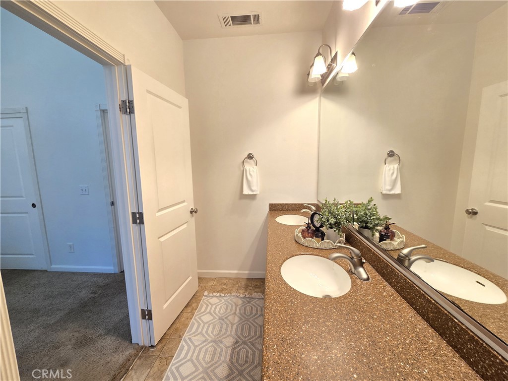 225 Sparrow Court Red Bluff, CA 96080 - Photo 18 of 29 a bathroom with a sink and a mirror