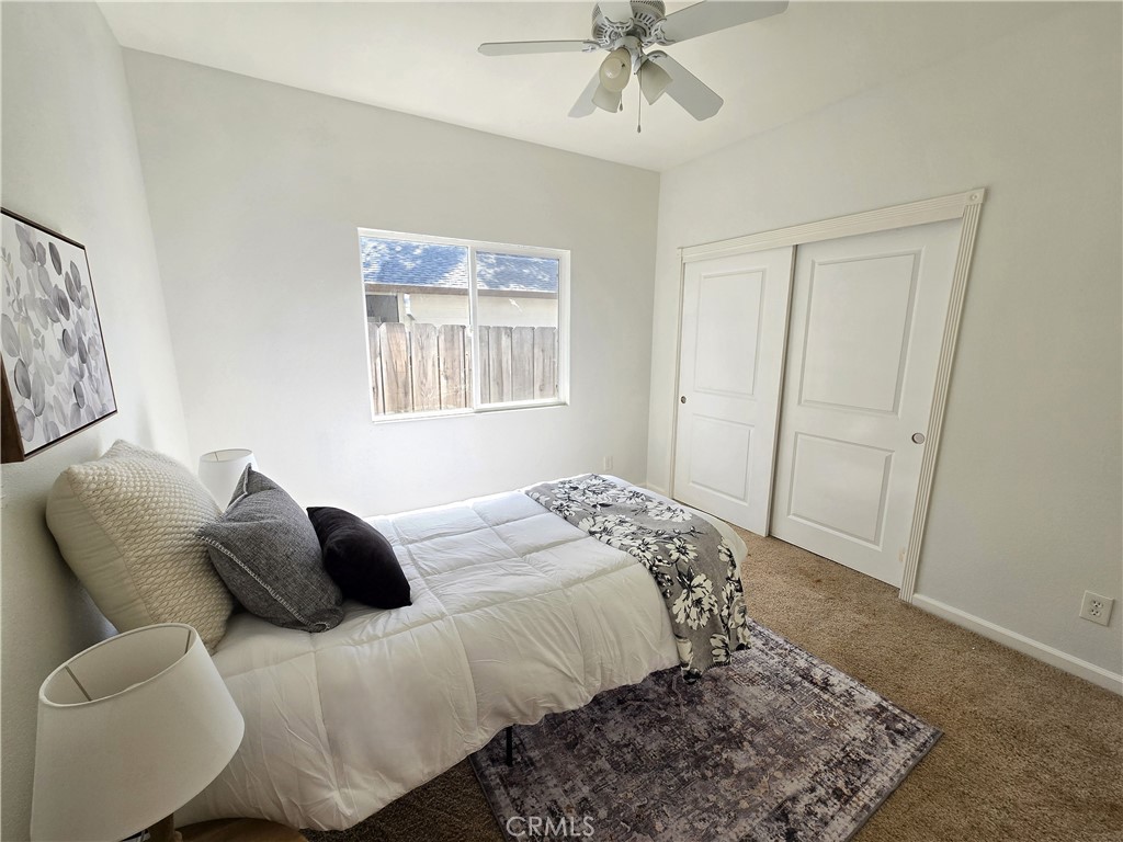 225 Sparrow Court Red Bluff, CA 96080 - Photo 19 of 29 a bedroom with a bed and wooden floor