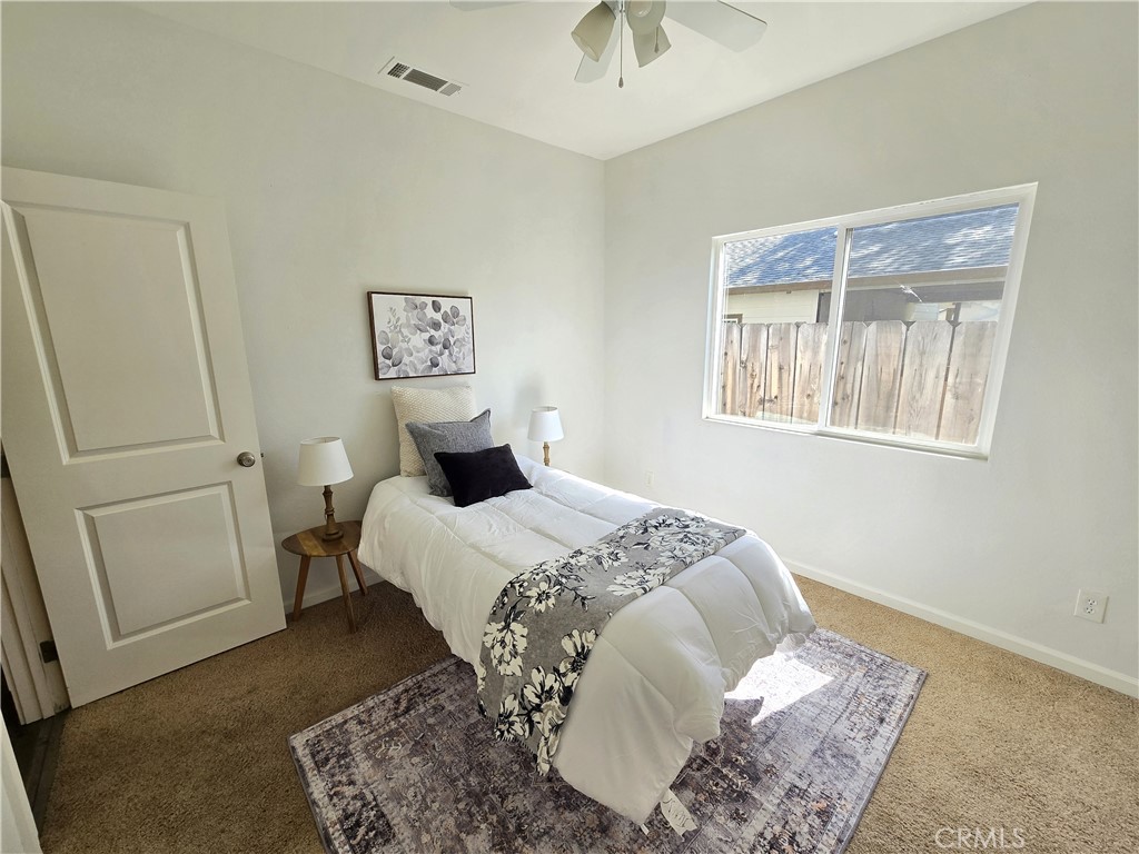 225 Sparrow Court Red Bluff, CA 96080 - Photo 20 of 29 a bedroom with a bed and wooden floor